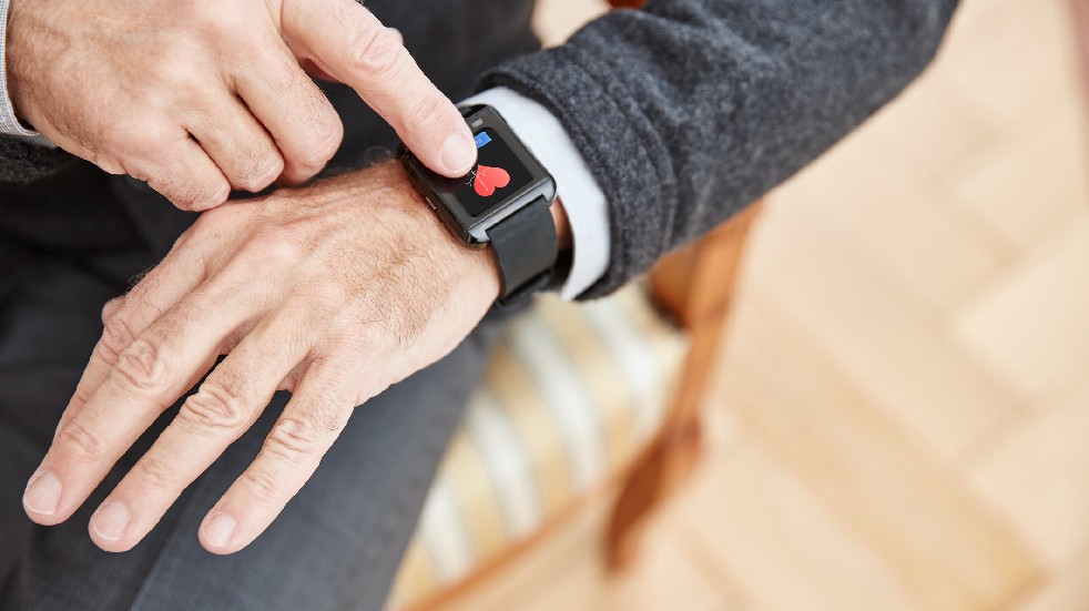 older person wearing a smart watch heart monitor 